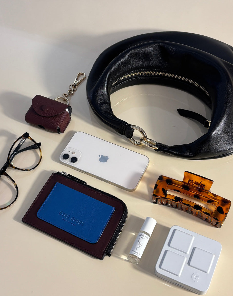 Black Piccola Ring Bag by HYER GOODS, a stylish hobo bag with gold accents, showing its spacious interior and compact design.