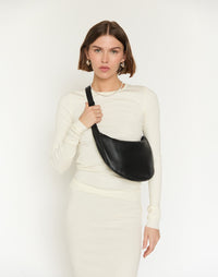 Black and silver Piccola Ring Bag by HYER GOODS, stylish hobo bag with circular ring handle and sleek design.