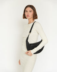 Black and silver Piccola Ring Bag by HYER GOODS, stylish hobo bag with unique ring detail and sleek design.