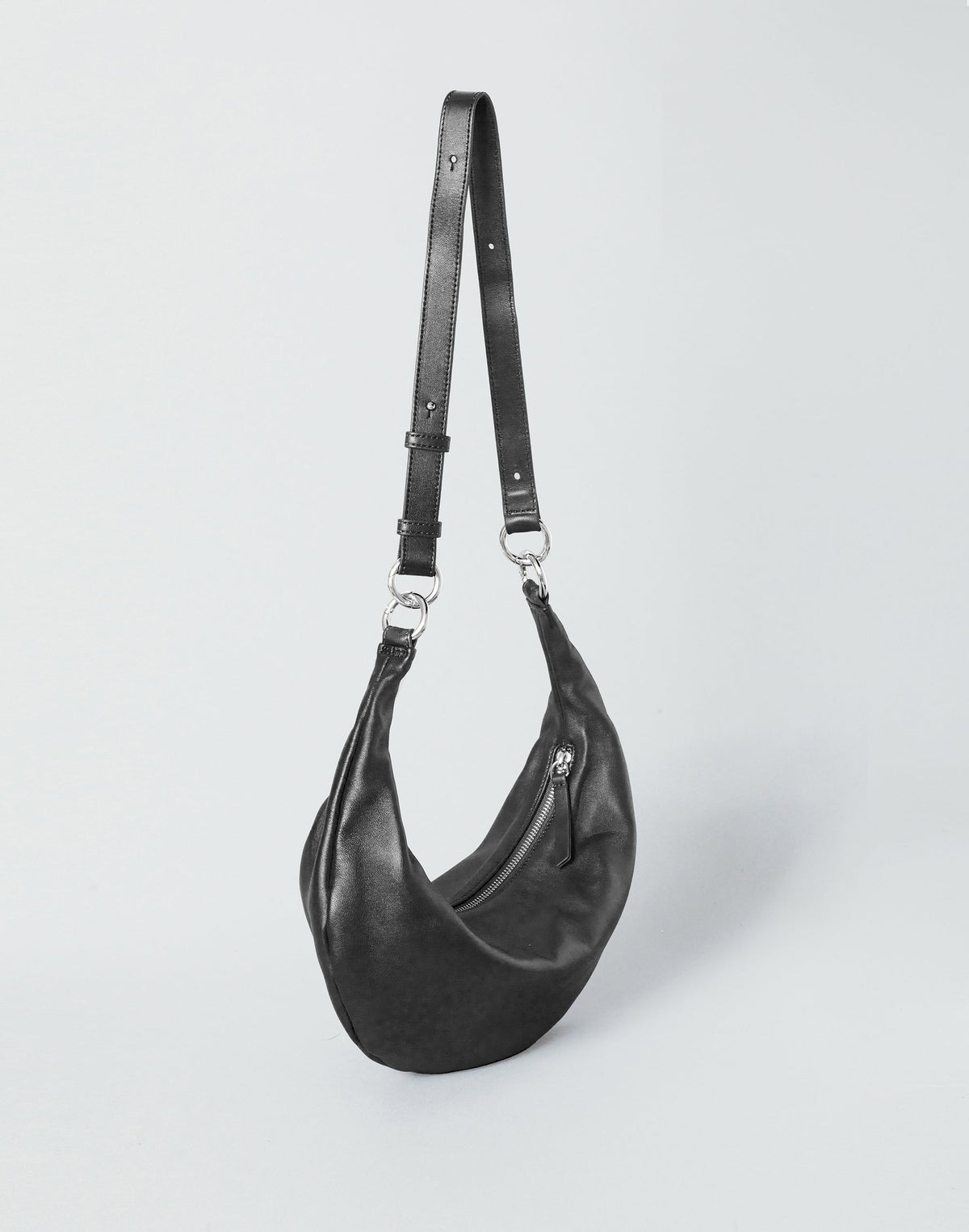 HYER GOODS Piccola Ring Bag in black and silver, a stylish hobo bag with a sleek design and circular ring detail.