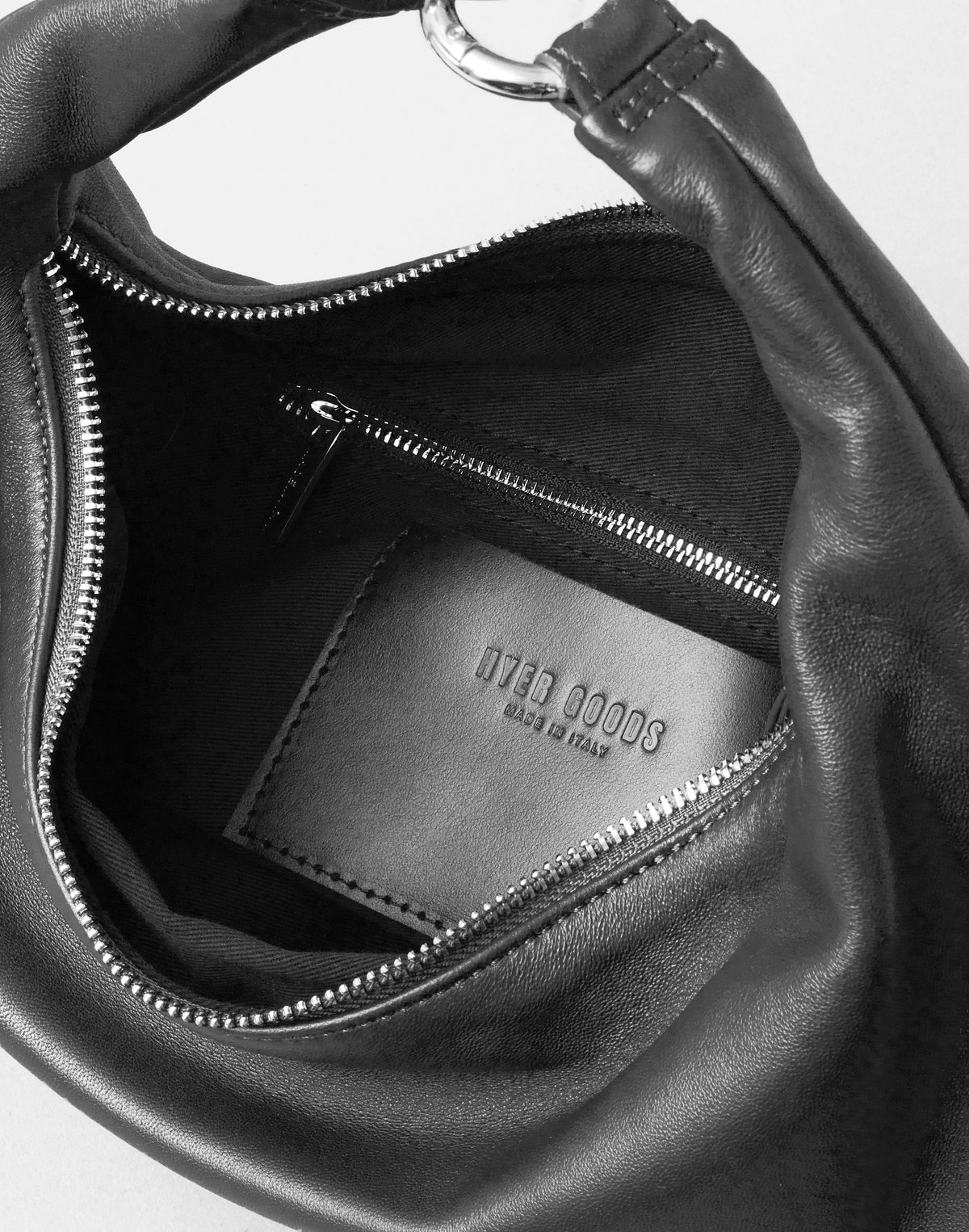 HYER GOODS Piccola Ring Bag hobo bag in black with silver accents, showing the interior and stylish design.