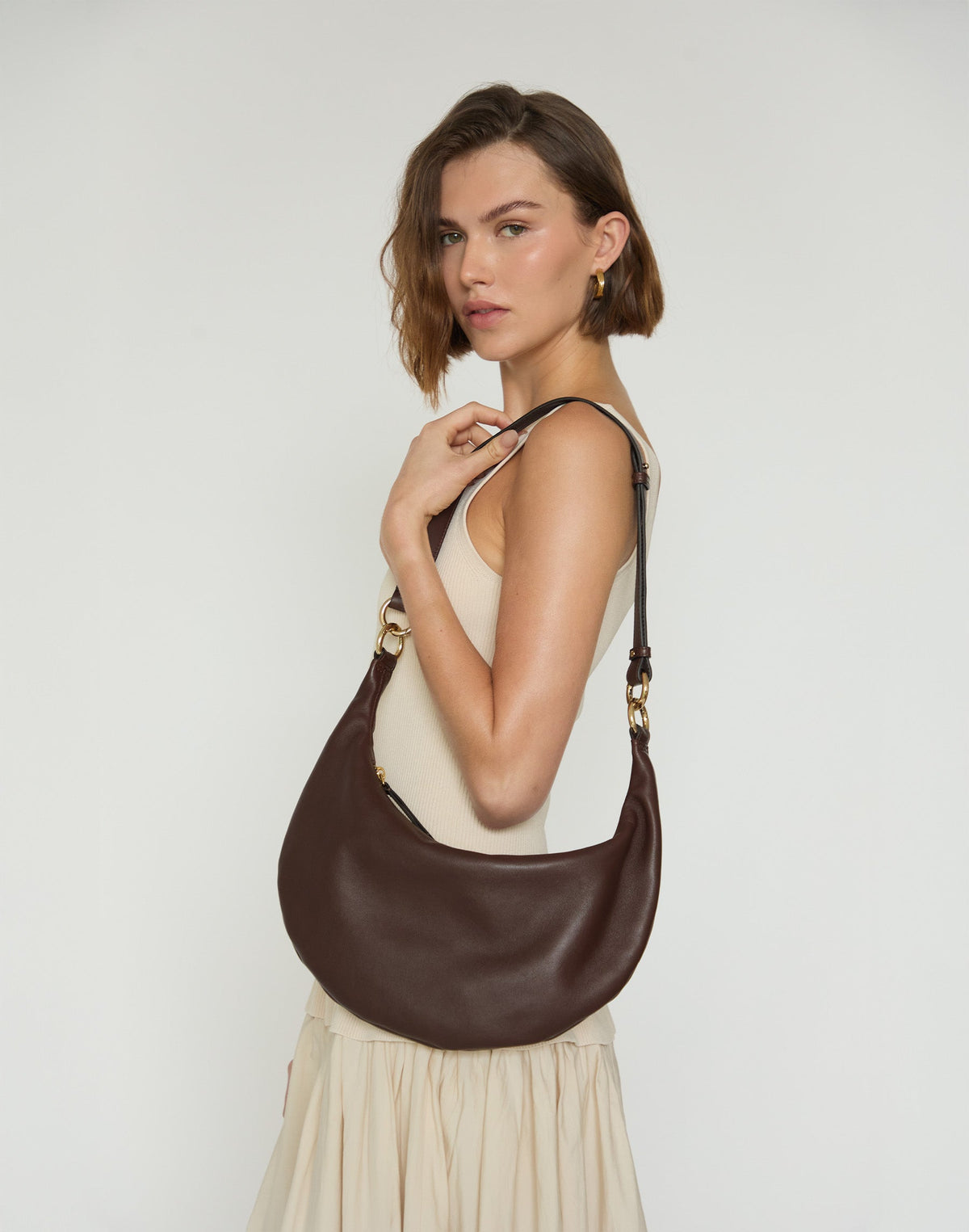 Hyer Goods Piccola Ring Bag, chocolate brown hobo bag with round handle and soft leather texture, stylish and compact.