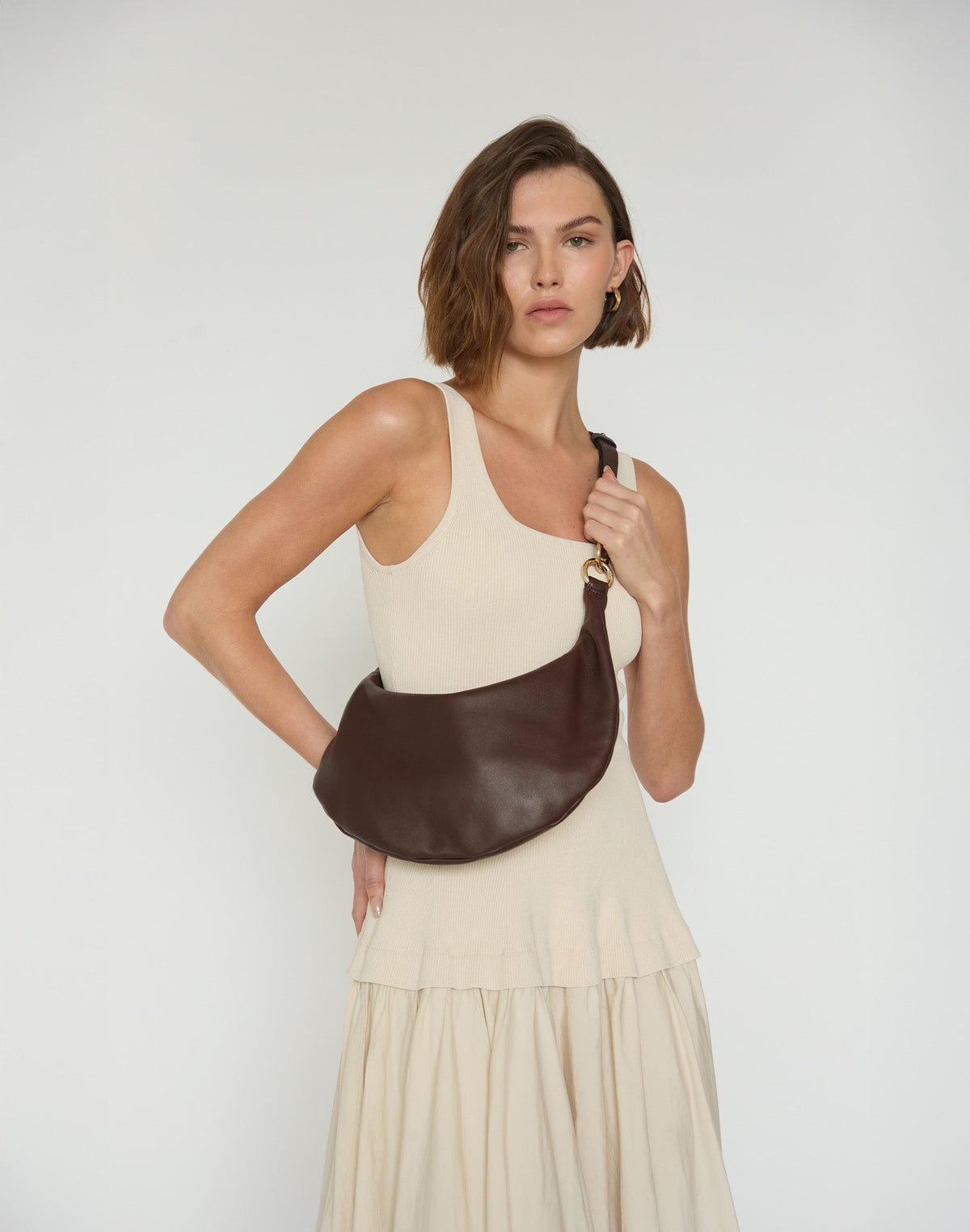 HYER GOODS Piccola Ring Bag hobo bag in chocolate brown leather with a circular handle and minimalist design.