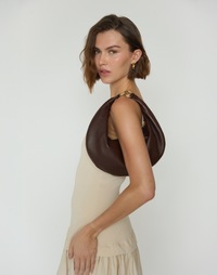 HYER GOODS Piccola Ring Bag, chocolate brown hobo bag with circular ring handle and soft leather texture.