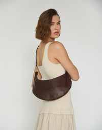 HYER GOODS Piccola Ring Bag hobo bag in chocolate leather with circular ring detail and adjustable strap.