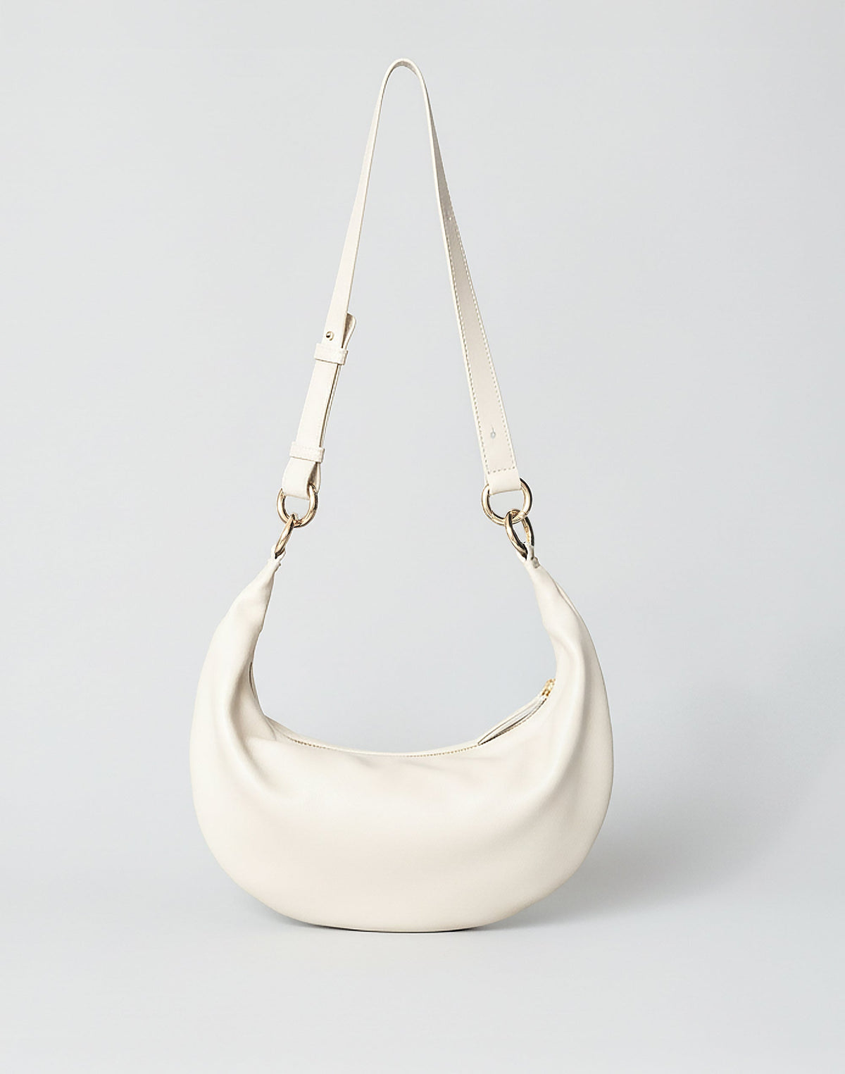Off-white Piccola Ring Bag by HYER GOODS, a stylish hobo bag with a unique ring detail and soft leather texture.
