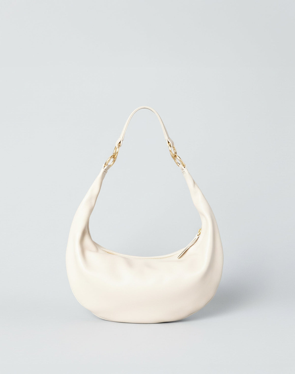 Off-white Piccola Ring Bag by HYER GOODS, a stylish hobo bag with a distinctive ring detail and soft, textured leather finish.