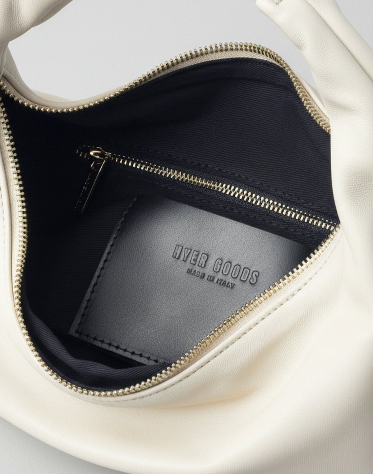 HYER GOODS Piccola Ring Bag hobo style in off-white with interior view showing round ring handle and soft leather material.