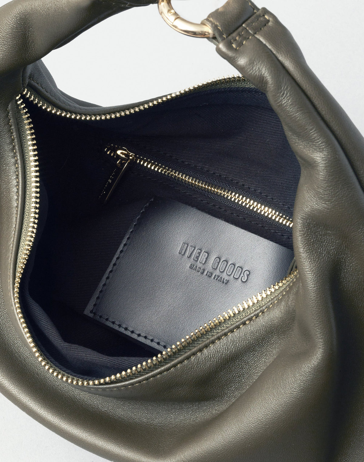 HYER GOODS Piccola Ring Bag in olive nappa leather, stylish hobo bag with circular handle and minimalist design.