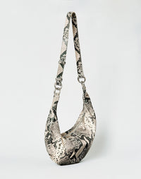 HYER GOODS Piccola Ring Bag hobo bag in python leather with circular ring handle and compact design.