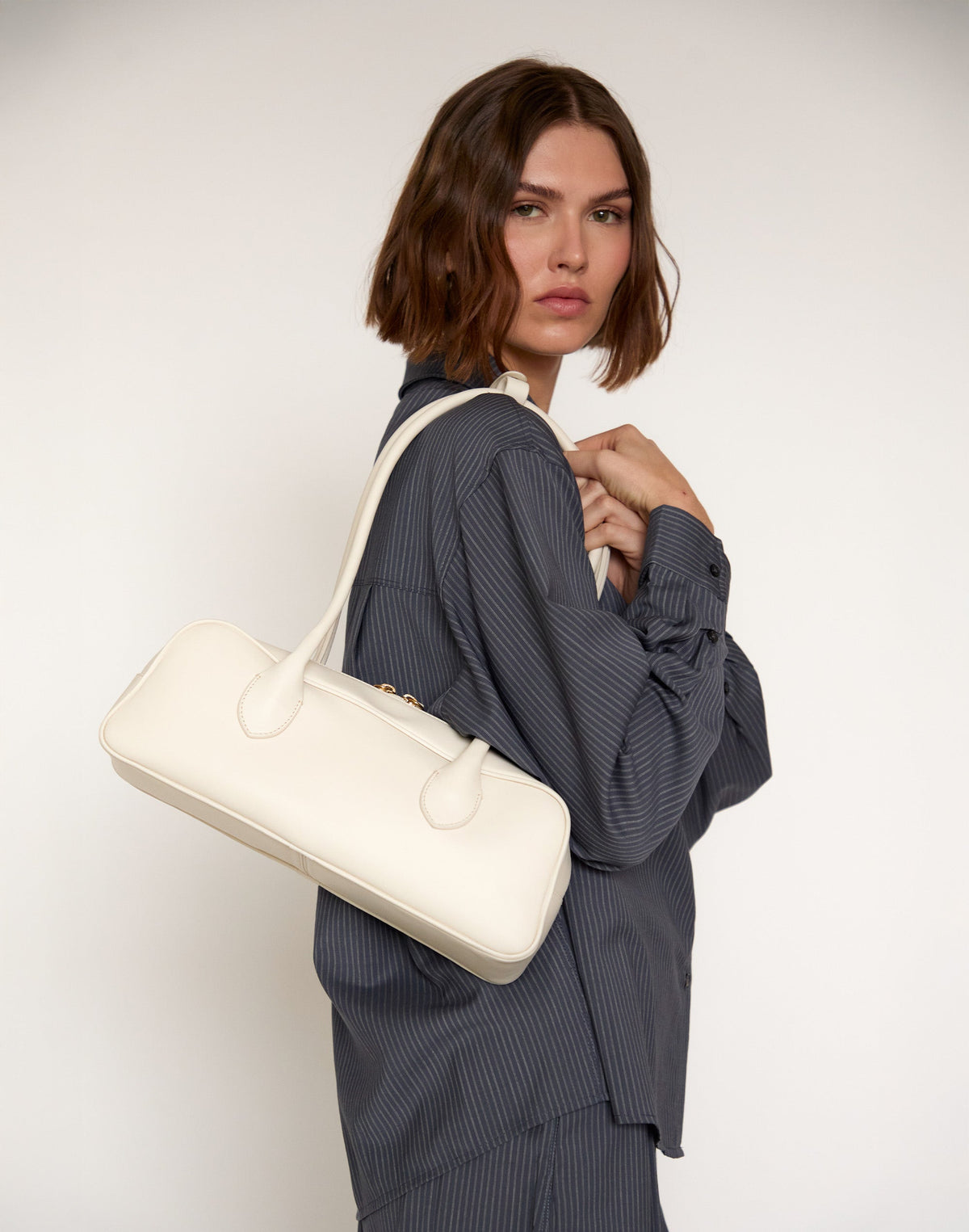 Off-white La Strada East West Shoulder Bag by HYER GOODS with sleek design and spacious interior, stylish accessory for everyday use.