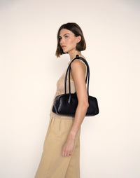 Black La Strada East West Shoulder Bag by HYER GOODS with sleek design and spacious interior, shown from side view.