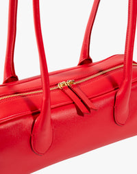 Red La Strada East West shoulder bag by HYER GOODS featuring sleek design and detailed stitching.