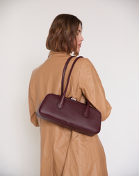 HYER GOODS La Strada East West Shoulder Bag in burgundy leather, showcasing stylish design and handcrafted details.