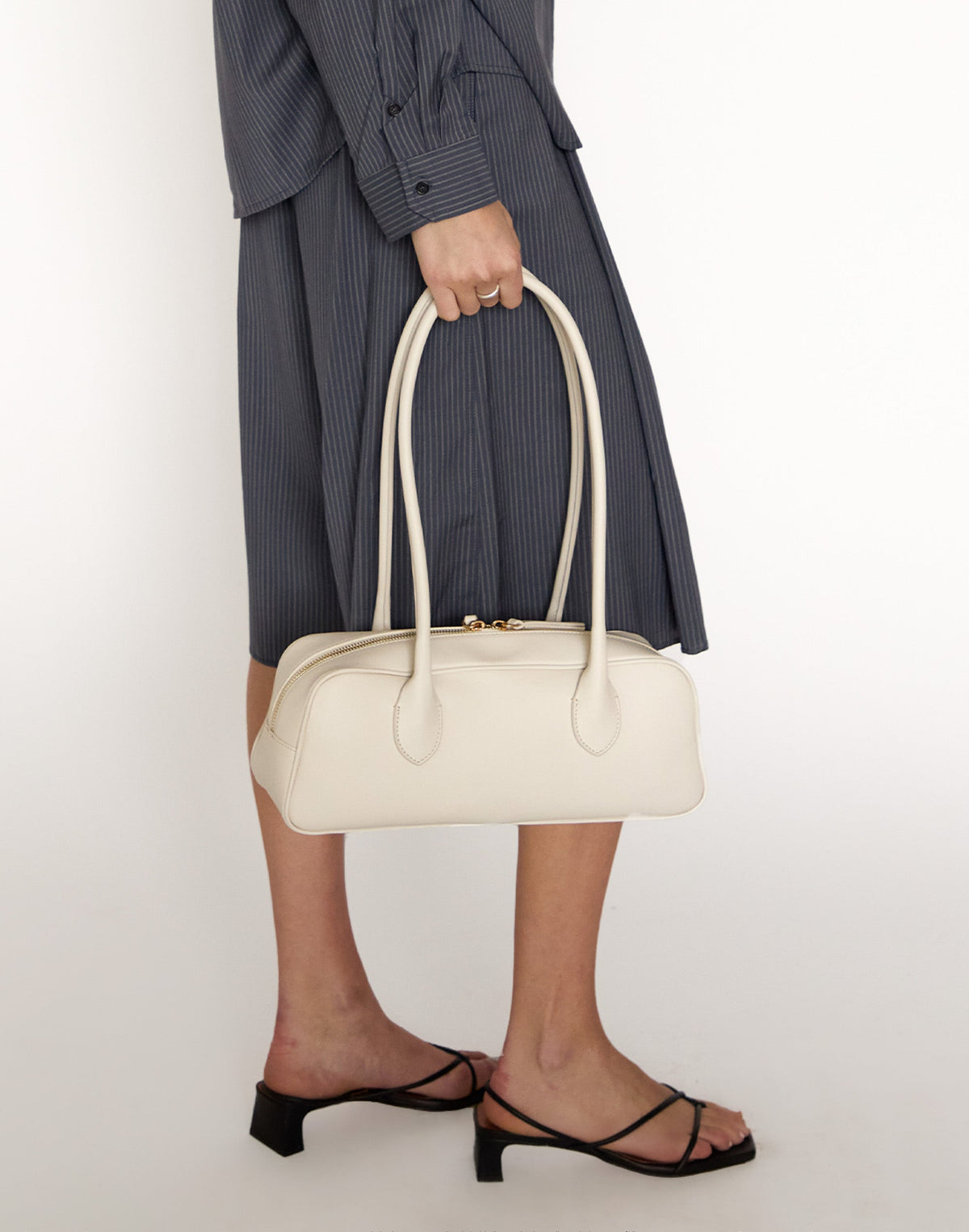 Off-white La Strada East West shoulder bag by HYER GOODS with sleek design and clean lines, featuring a spacious interior and stylish look.