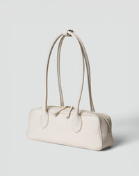 HYER GOODS La Strada East West Shoulder Bag in off-white with sleek design and adjustable strap, perfect for everyday use.