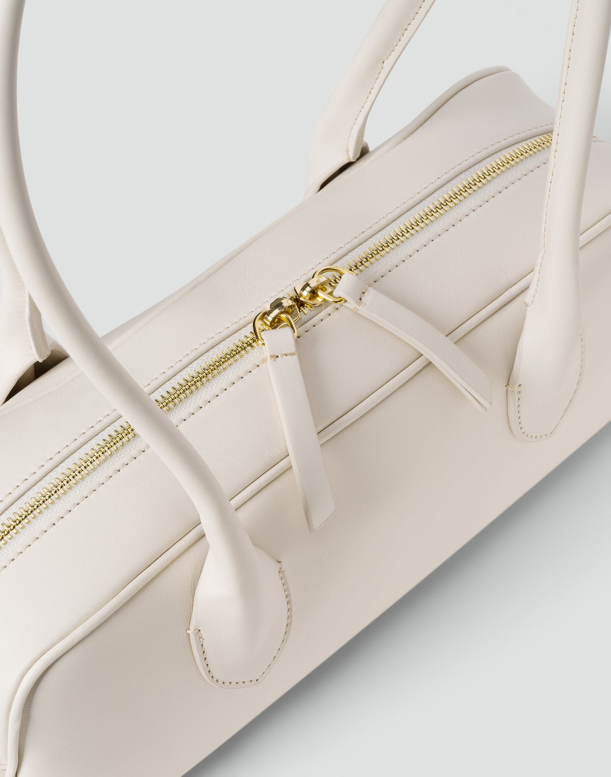 White La Strada East West Shoulder Bag by HYER GOODS showcasing its sleek, minimalist design with a top handle and spacious interior.