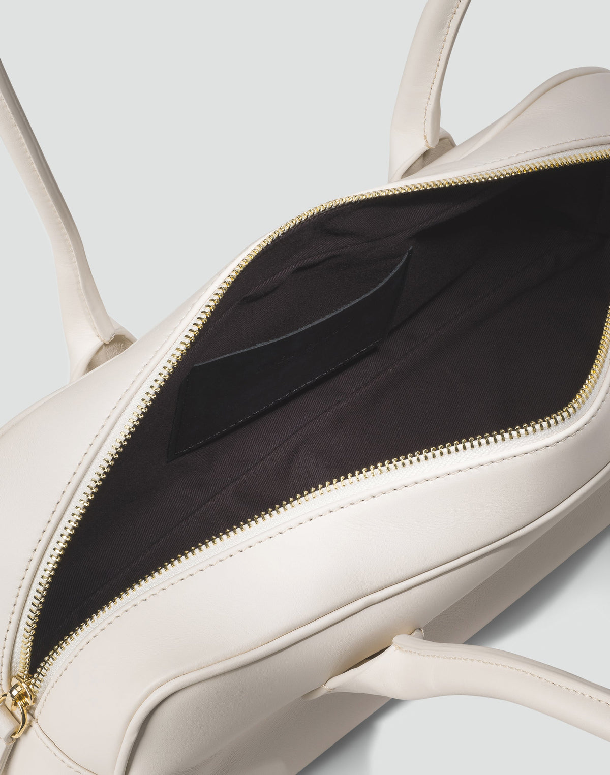 White La Strada East West Shoulder Bag by HYER GOODS featuring a sleek, minimalist design and adjustable shoulder strap.