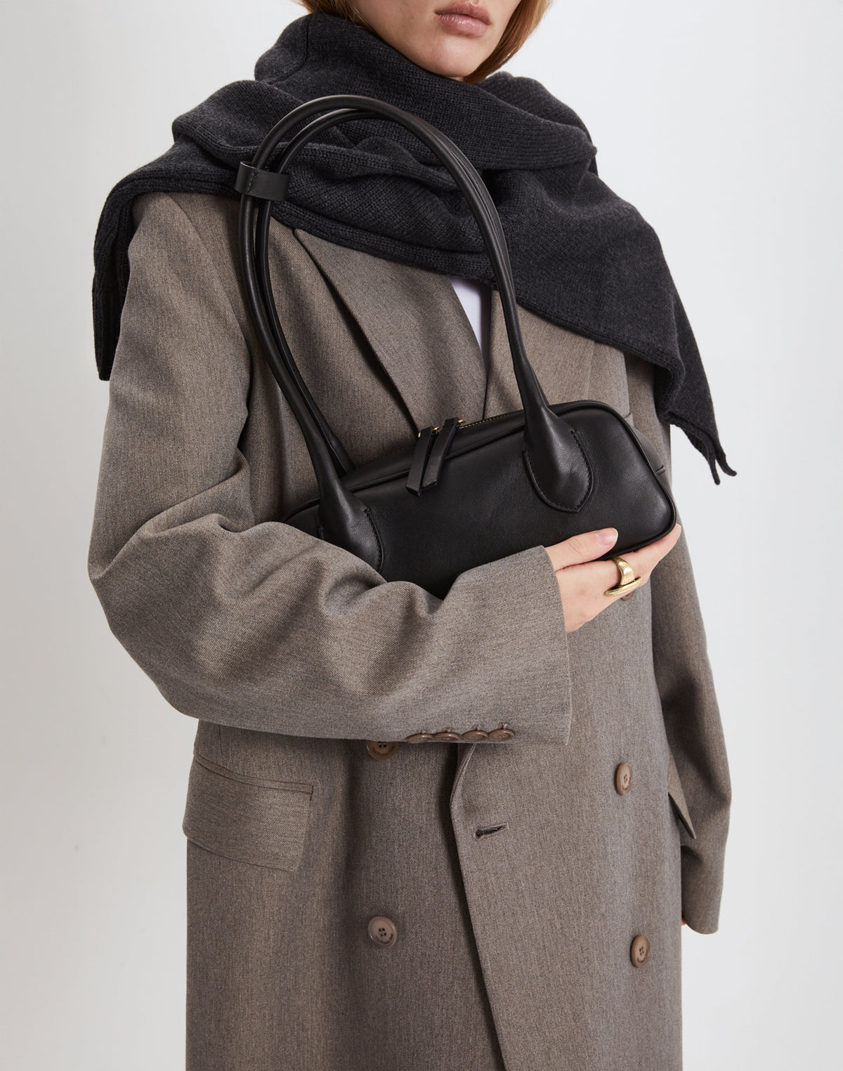 HYER GOODS Mini La Strada East West Shoulder Bag in black with gold accents, showcasing its compact design and stylish craftsmanship.