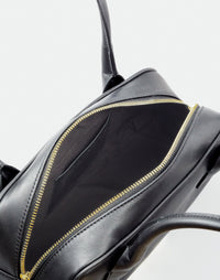 Black and gold Mini La Strada East West Shoulder Bag by HYER GOODS with sleek design and adjustable strap.