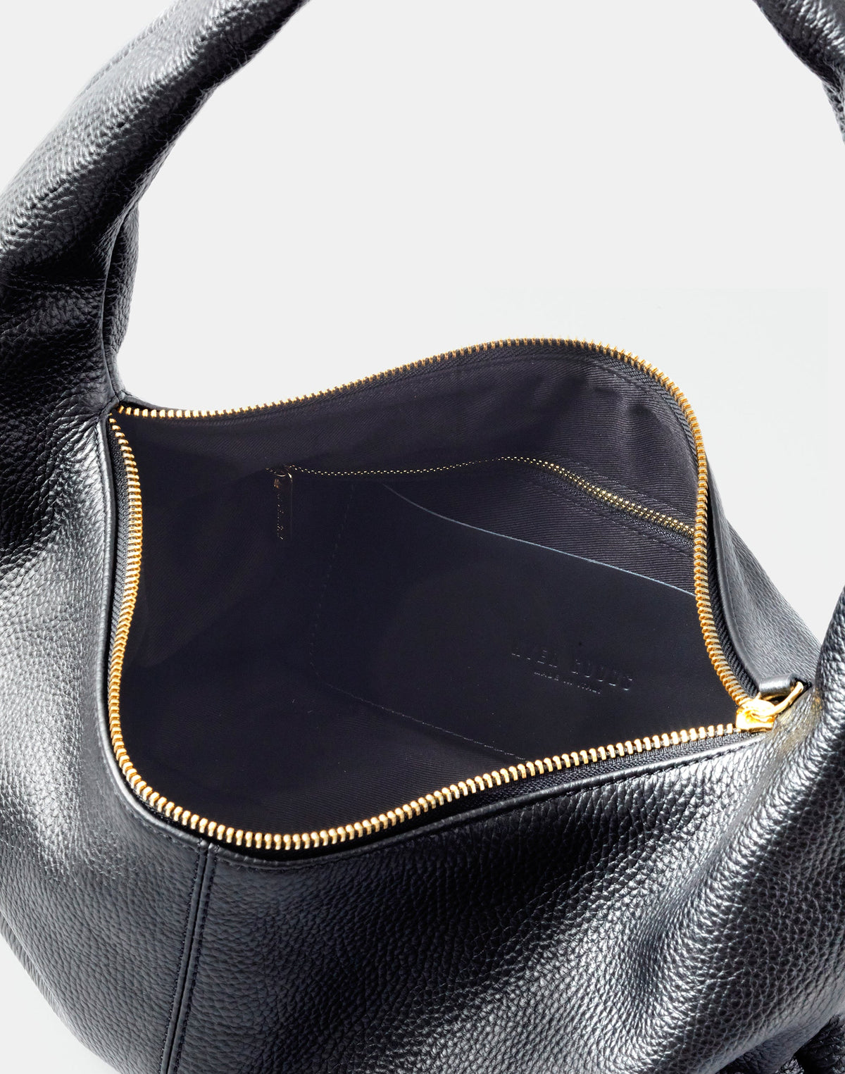 Black and gold HYER GOODS Everyday Shoulder Bag with sleek design and adjustable shoulder strap, displayed on a neutral background.