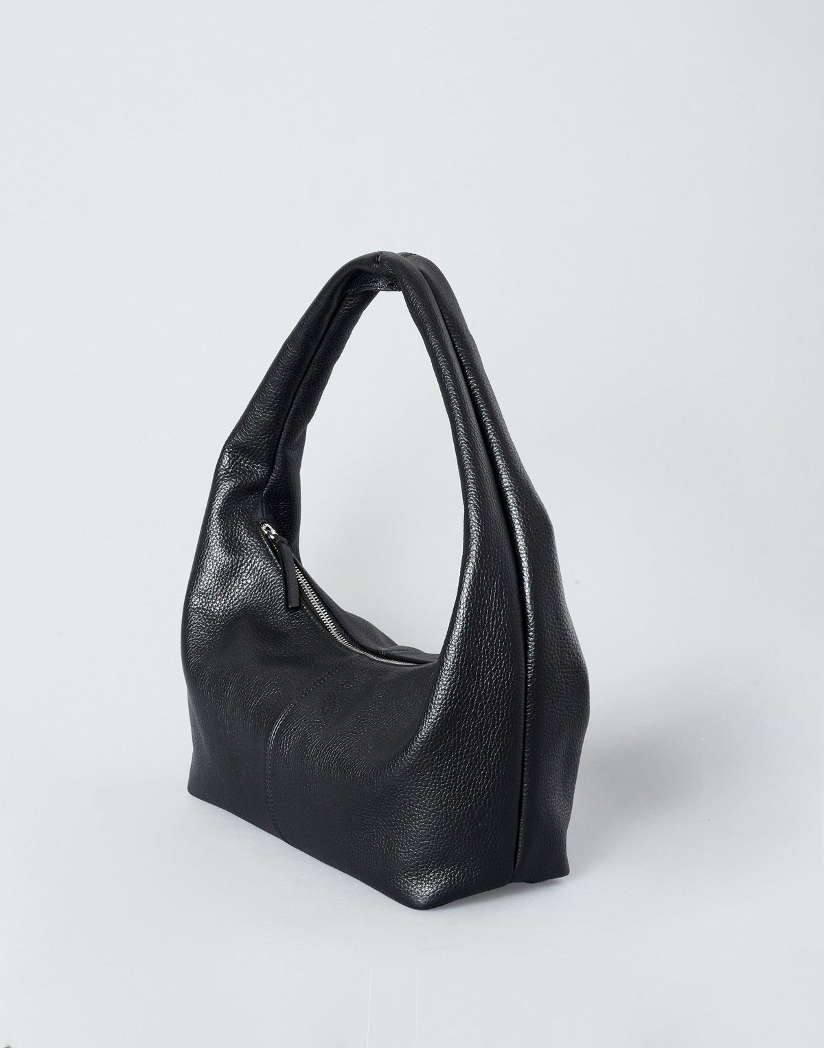 Black HYER GOODS Everyday Shoulder Bag with silver hardware, showcasing its sleek design and shoulder strap in a detailed view.