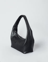 Black HYER GOODS Everyday Shoulder Bag with silver hardware, showcasing its sleek design and shoulder strap in a detailed view.