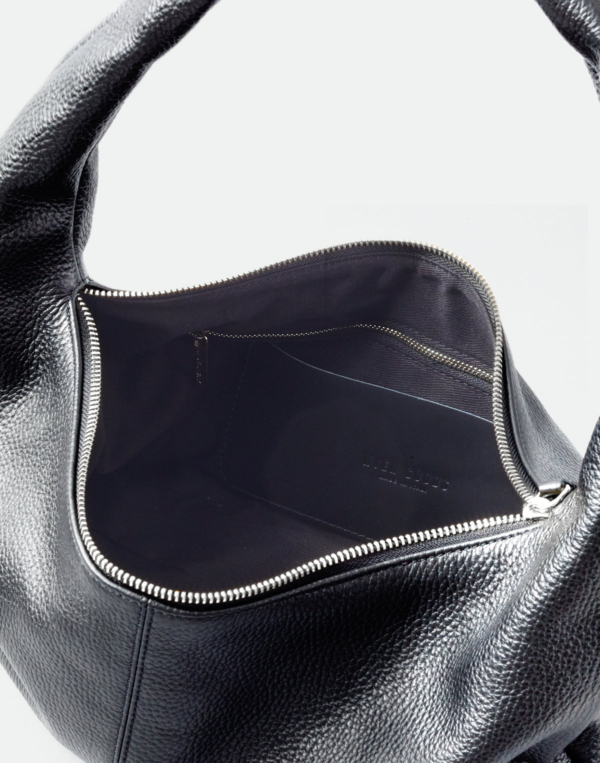 Black HYER GOODS Everyday Shoulder Bag with silver hardware, showing its sleek design and adjustable strap.