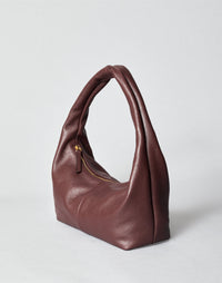 HYER GOODS Everyday Shoulder Bag in burgundy gold color, featuring a sleek leather design and adjustable strap.