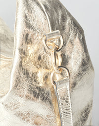 Gold mini everyday shoulder bag by HYER GOODS showing a compact leather bag with a shoulder strap on a neutral background.