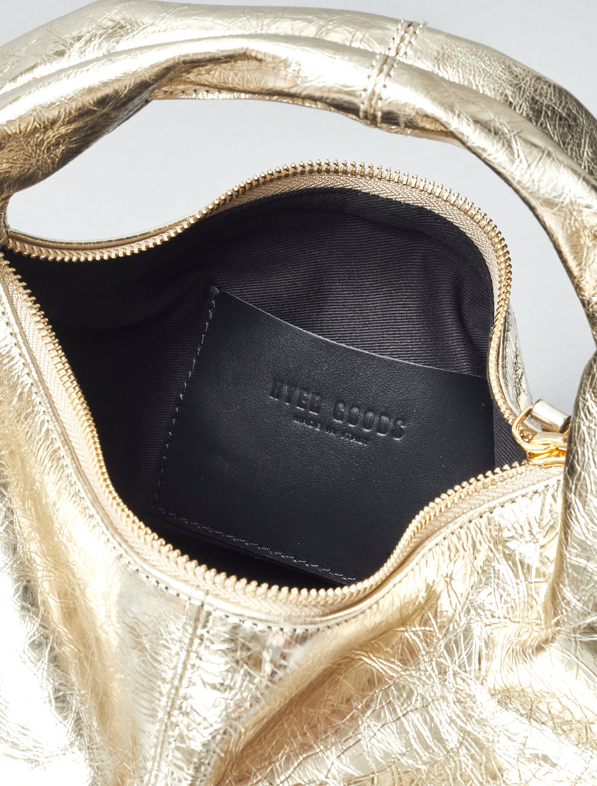 Gold mini everyday shoulder bag by HYER GOODS with sleek design and compact size, perfect for daily use.