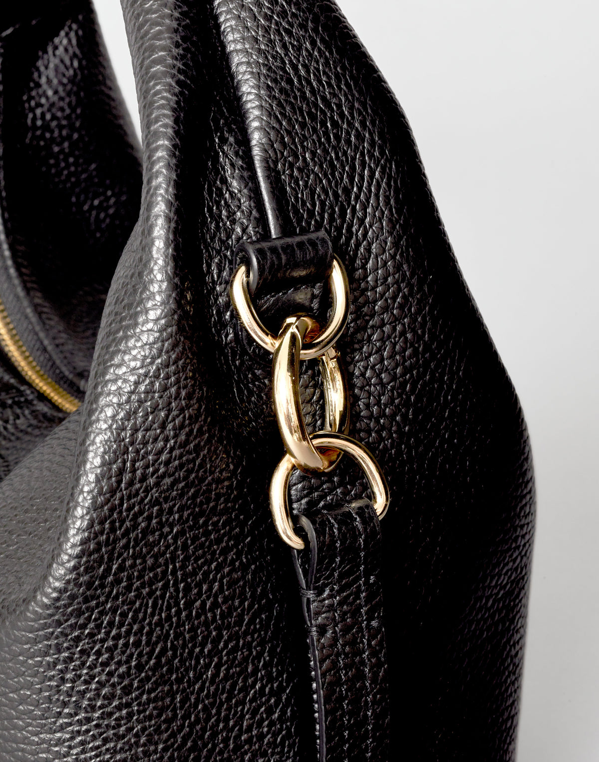 Black mini everyday shoulder bag by HYER GOODS, featuring a sleek design with gold accents and compact size.