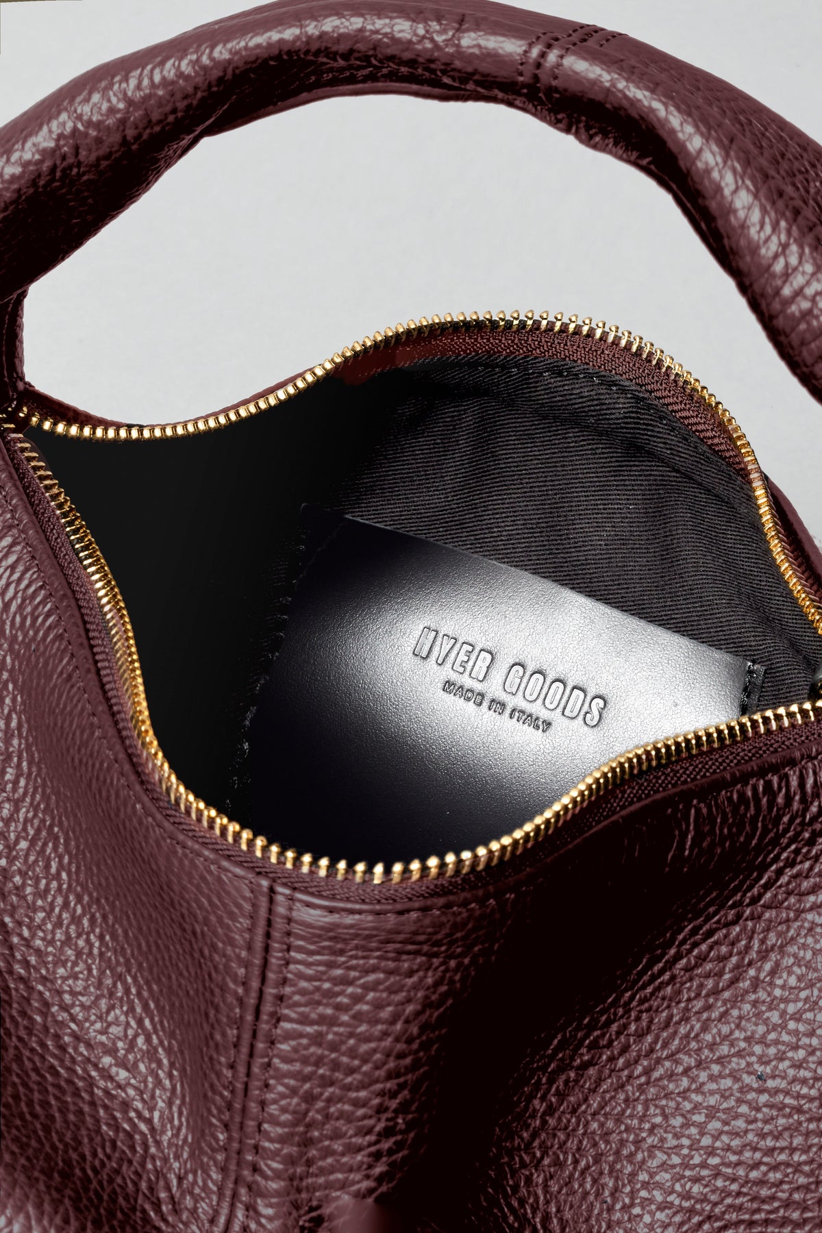 Mini Everyday Shoulder Bag by HYER GOODS in burgundy with a sleek design, featuring a shoulder strap and minimalist style.