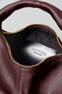 Mini Everyday Shoulder Bag by HYER GOODS in burgundy with a sleek design, featuring a shoulder strap and minimalist style.