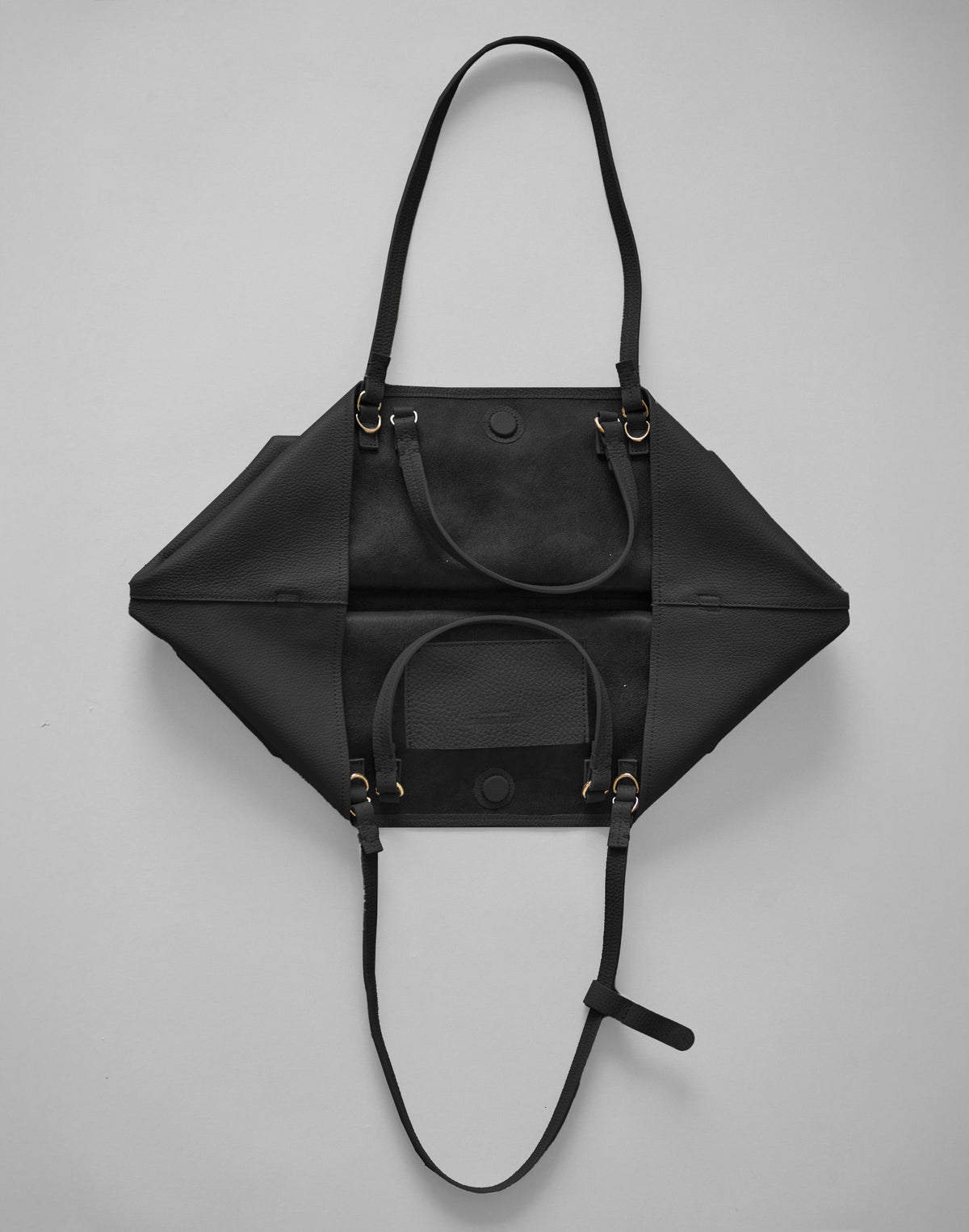 Black HYER GOODS Mercato tote bag with soft material, interior pocket, and phone holder visible inside.