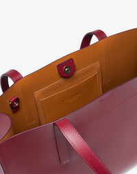 HYER GOODS Tolentino tote bag in double-face burgundy leather, showing the spacious interior and stylish design.