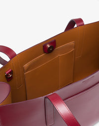 HYER GOODS Tolentino tote bag in double-face burgundy leather, showing the spacious interior and stylish design.