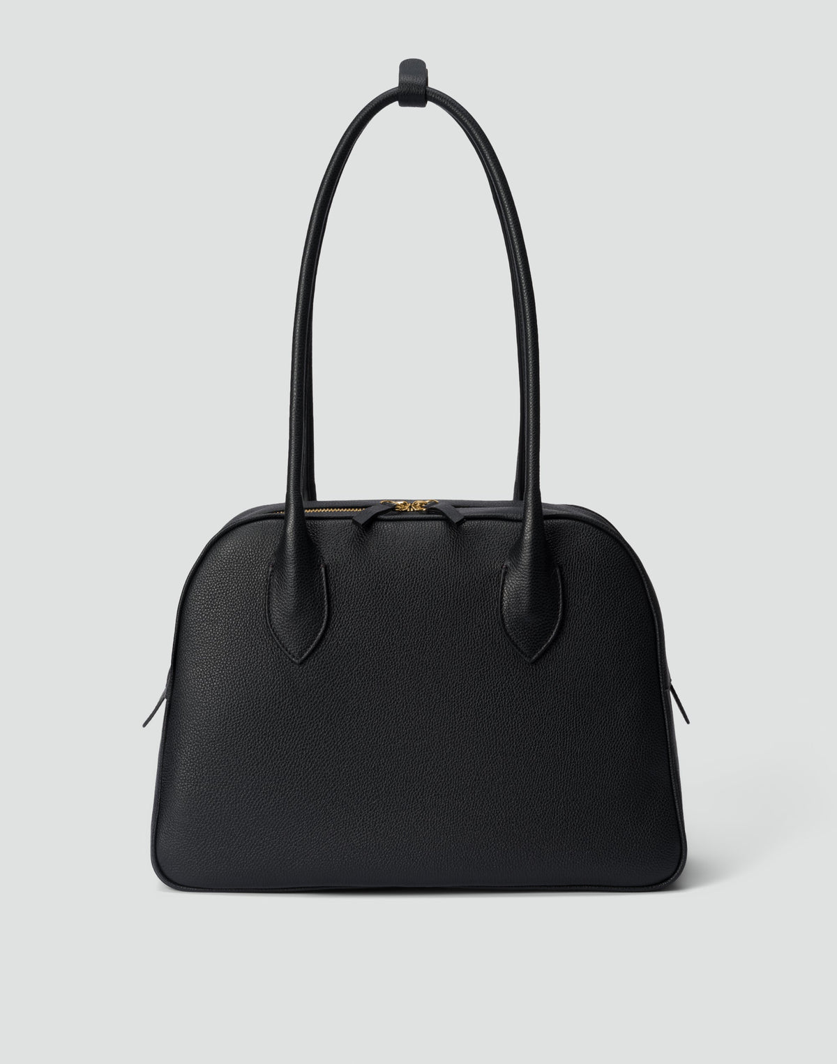 HYER GOODS La Autostrada tote bag in black and gold with sturdy handles and spacious interior on a plain background.