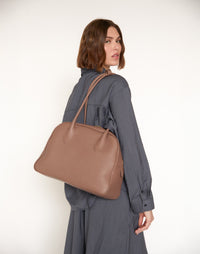 Taupe HYER GOODS La Autostrada tote bag with shoulder straps, showcasing its stylish, spacious design for everyday use.