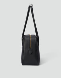 Black and gold La Autostrada tote bag by HYER GOODS with sleek design and sturdy handles, shown from a front view.