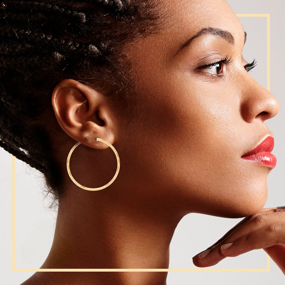 Model wearing JB Jewelry BLVD slit cut 14K gold-filled hoop earrings, 25-80mm design hoops for women, stylish and elegant.