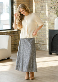 Inherit Co. Zadie Ivory short sleeve button cardigan from IC Layering Essentials, featuring a cozy knit design and front buttons.