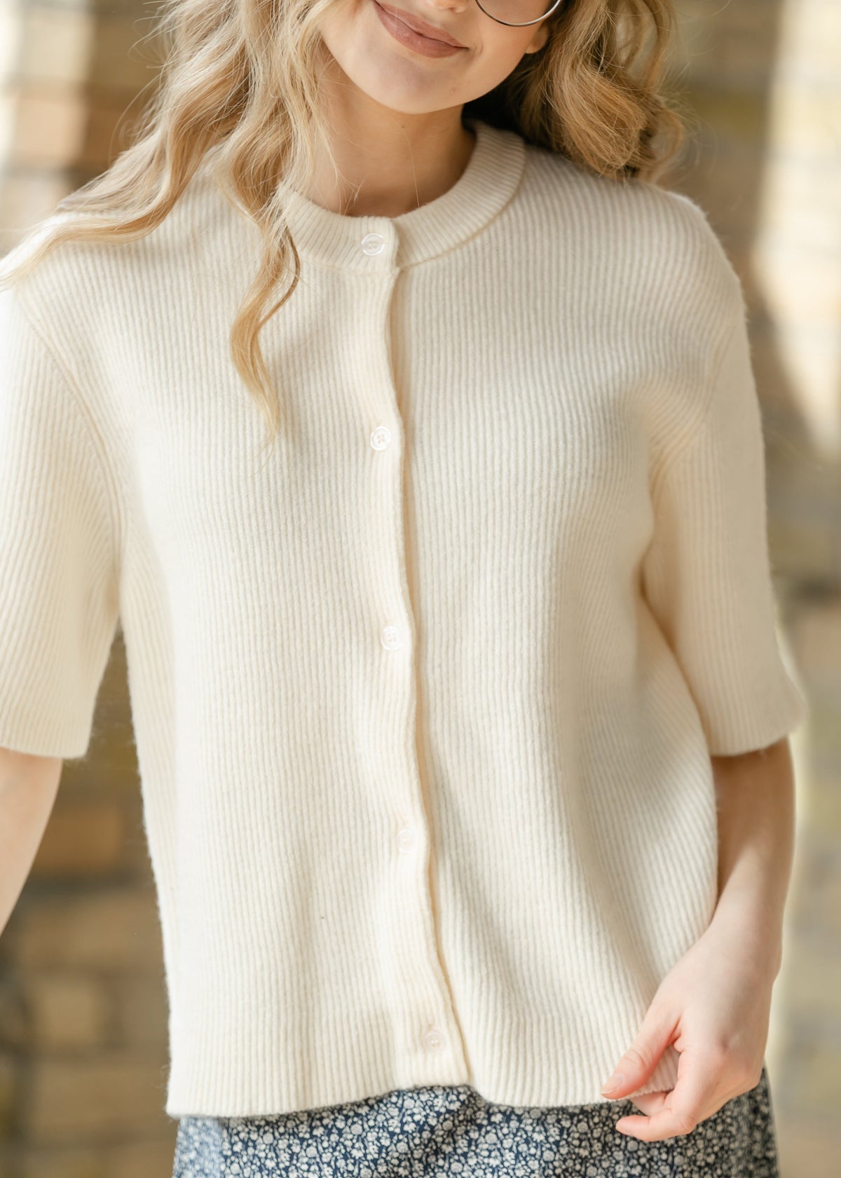 Ivory short sleeve button cardigan from Inherit Co.'s Zadie IC Layering Essentials collection, shown on a model.
