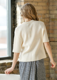 Ivory short sleeve button cardigan from Inherit Co.'s IC Layering Essentials, featuring a cozy, stylish design.