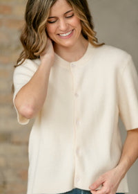 Ivory short sleeve button cardigan from Inherit Co.'s IC Layering Essentials, featuring a cozy, lightweight knit and stylish design.
