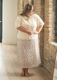 Inherit Co. Zadie Ivory short-sleeve button cardigan from IC Layering Essentials, shown in a close-up of the lightweight knit fabric.