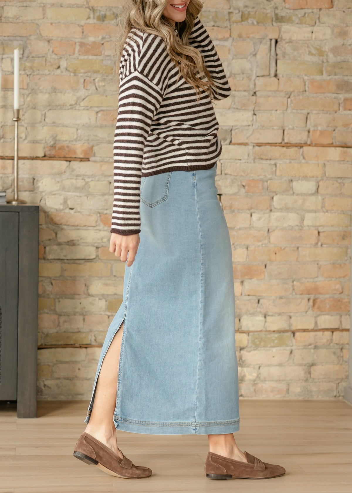 Light wash denim maxi skirt from Inherit Co., featuring a flowing silhouette and classic denim details.