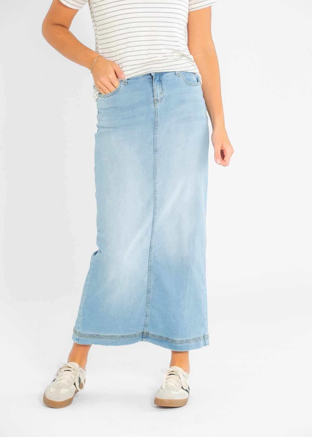 Light wash denim maxi skirt from Inherit Co. featuring a flowing silhouette and classic jean styling.