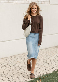 Inherit Co. Drew Raw Hem Midi Denim Skirt with classic blue wash, button front, and raw hem details, styled on a model.