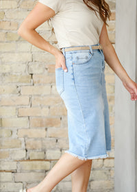 Inherit Co. Drew Raw Hem Midi Denim Skirt, featuring a classic denim fabric with a raw hem detail and midi length.